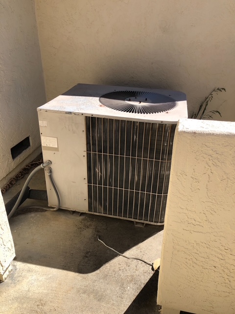 Old outdoor AC condenser before replacement
