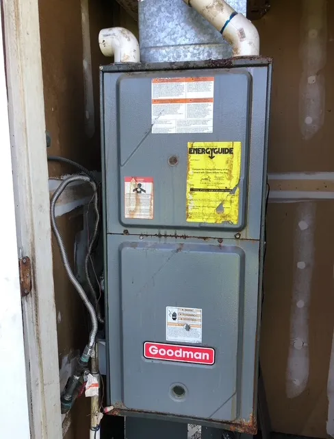 Rusting furnace in exterior closet before replacement service