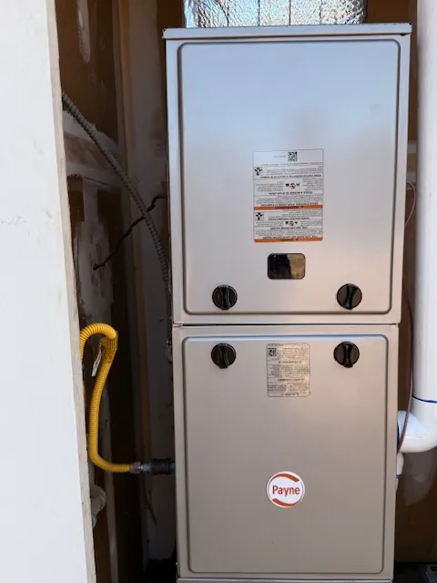 Modern high-efficiency furnace installed in exterior closet after replacement
